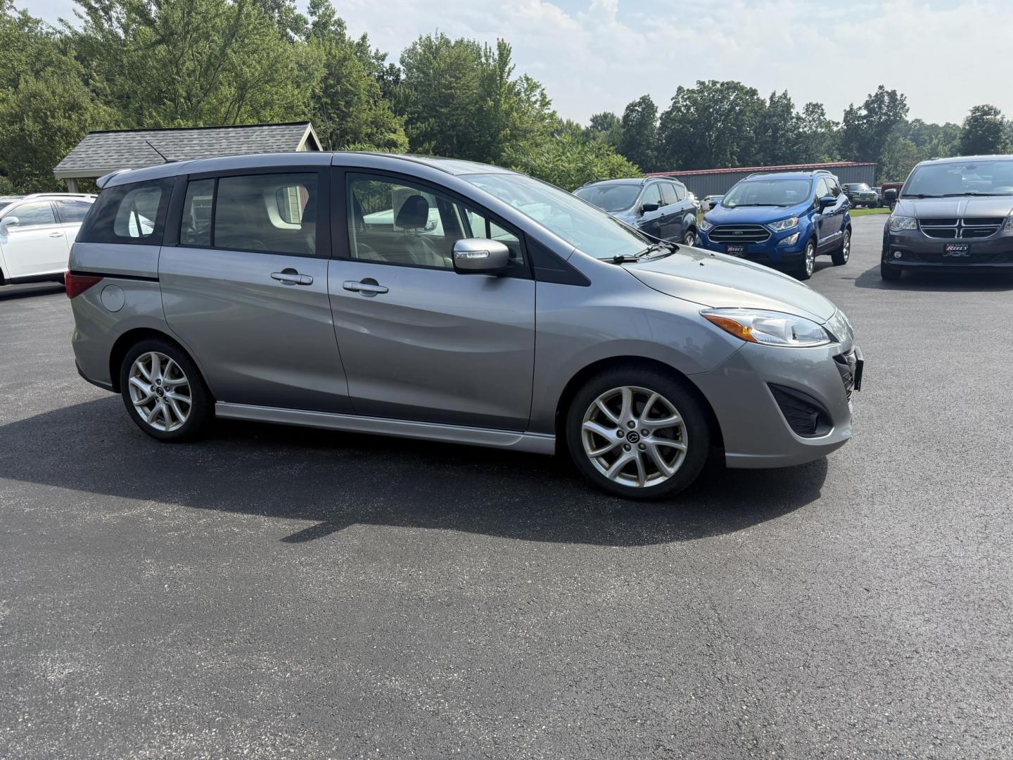 2015 Silver /Black Mazda MAZDA5 Grand Touring (JM1CW2DL0F0) with an 2.5L I4 DOHC 16V engine, 5-Speed Automatic transmission, located at 11115 Chardon Rd. , Chardon, OH, 44024, (440) 214-9705, 41.580246, -81.241943 - This 2015 Mazda Mazda 5 with a 2.5L I4 engine and 5-speed automatic transmission offers a versatile and comfortable minivan, achieving approximately 29 MPG highway. It features a leather interior, second-row captain’s seats, heated front seats, automatic climate control, a power moonroof, dusk-sen - Photo#3