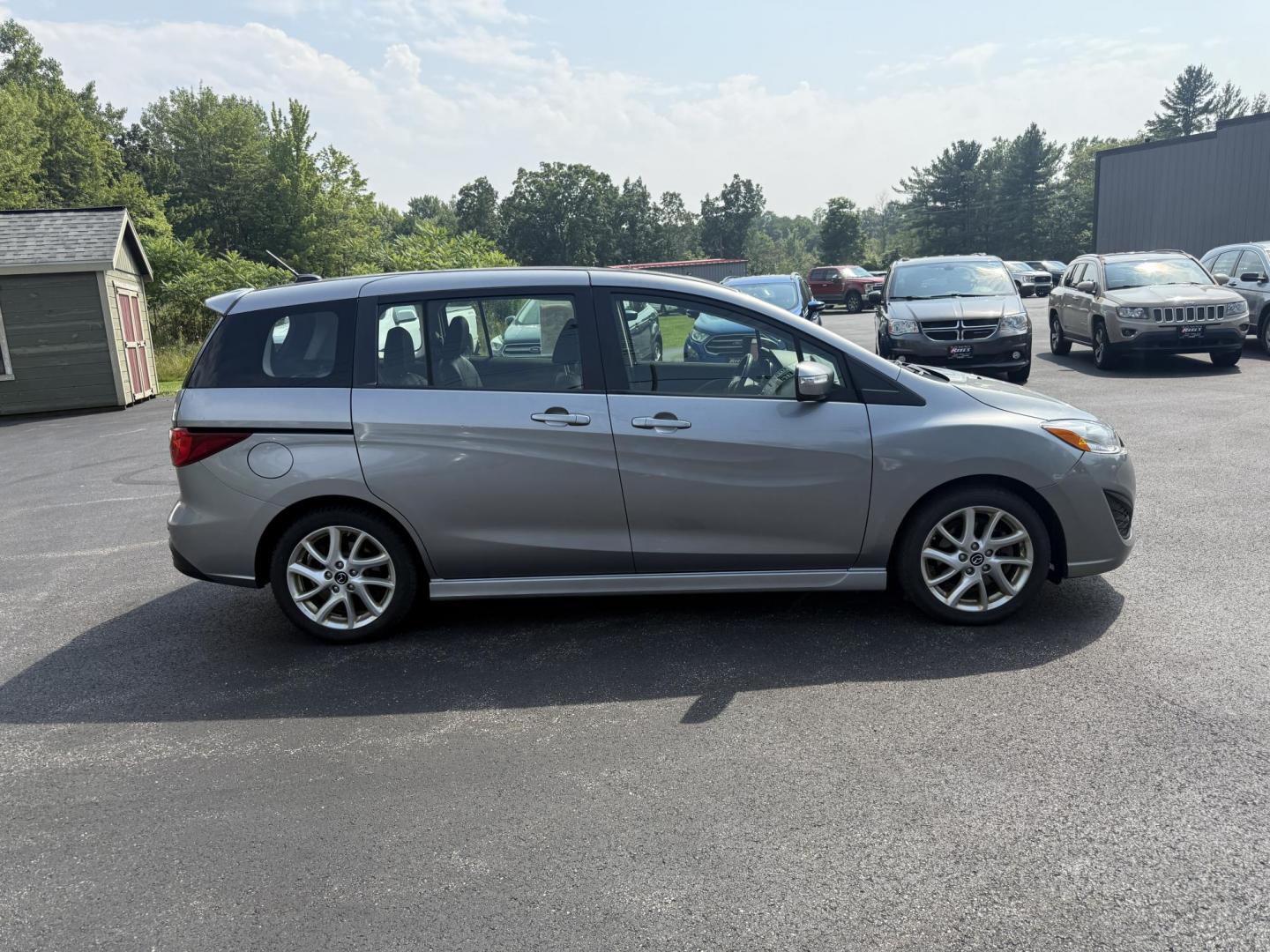 2015 Silver /Black Mazda MAZDA5 Grand Touring (JM1CW2DL0F0) with an 2.5L I4 DOHC 16V engine, 5-Speed Automatic transmission, located at 11115 Chardon Rd. , Chardon, OH, 44024, (440) 214-9705, 41.580246, -81.241943 - This 2015 Mazda Mazda 5 with a 2.5L I4 engine and 5-speed automatic transmission offers a versatile and comfortable minivan, achieving approximately 29 MPG highway. It features a leather interior, second-row captain’s seats, heated front seats, automatic climate control, a power moonroof, dusk-sen - Photo#5