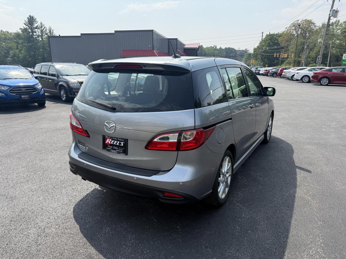2015 Silver /Black Mazda MAZDA5 Grand Touring (JM1CW2DL0F0) with an 2.5L I4 DOHC 16V engine, 5-Speed Automatic transmission, located at 11115 Chardon Rd. , Chardon, OH, 44024, (440) 214-9705, 41.580246, -81.241943 - This 2015 Mazda Mazda 5 with a 2.5L I4 engine and 5-speed automatic transmission offers a versatile and comfortable minivan, achieving approximately 29 MPG highway. It features a leather interior, second-row captain’s seats, heated front seats, automatic climate control, a power moonroof, dusk-sen - Photo#7