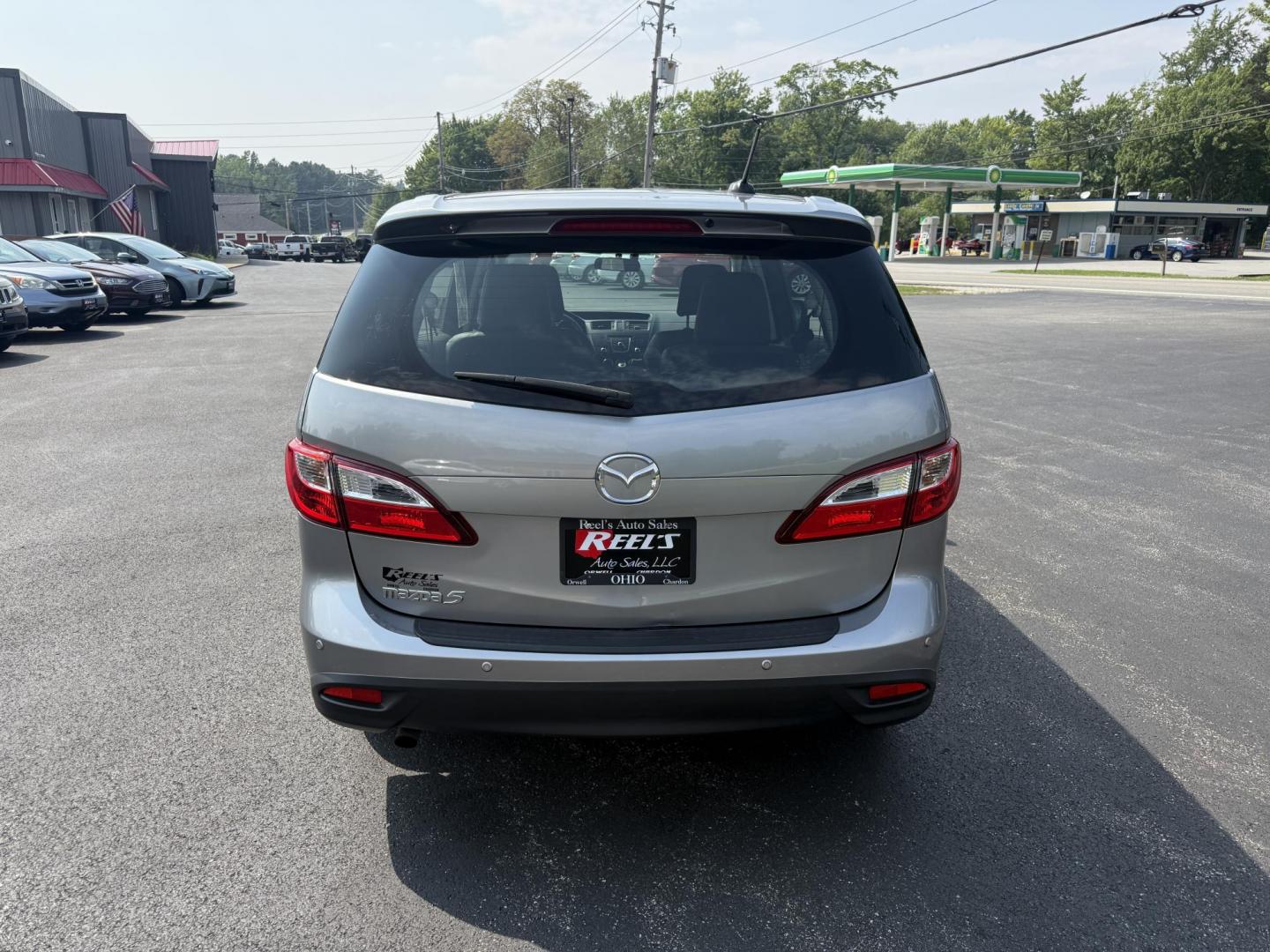 2015 Silver /Black Mazda MAZDA5 Grand Touring (JM1CW2DL0F0) with an 2.5L I4 DOHC 16V engine, 5-Speed Automatic transmission, located at 11115 Chardon Rd. , Chardon, OH, 44024, (440) 214-9705, 41.580246, -81.241943 - This 2015 Mazda Mazda 5 with a 2.5L I4 engine and 5-speed automatic transmission offers a versatile and comfortable minivan, achieving approximately 29 MPG highway. It features a leather interior, second-row captain’s seats, heated front seats, automatic climate control, a power moonroof, dusk-sen - Photo#8