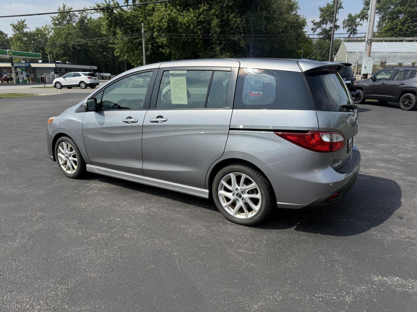 2015 Silver /Black Mazda MAZDA5 Grand Touring (JM1CW2DL0F0) with an 2.5L I4 DOHC 16V engine, 5-Speed Automatic transmission, located at 11115 Chardon Rd. , Chardon, OH, 44024, (440) 214-9705, 41.580246, -81.241943 - This 2015 Mazda Mazda 5 with a 2.5L I4 engine and 5-speed automatic transmission offers a versatile and comfortable minivan, achieving approximately 29 MPG highway. It features a leather interior, second-row captain’s seats, heated front seats, automatic climate control, a power moonroof, dusk-sen - Photo#10