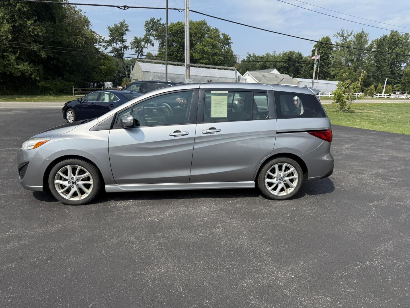 2015 Silver /Black Mazda MAZDA5 Grand Touring (JM1CW2DL0F0) with an 2.5L I4 DOHC 16V engine, 5-Speed Automatic transmission, located at 11115 Chardon Rd. , Chardon, OH, 44024, (440) 214-9705, 41.580246, -81.241943 - This 2015 Mazda Mazda 5 with a 2.5L I4 engine and 5-speed automatic transmission offers a versatile and comfortable minivan, achieving approximately 29 MPG highway. It features a leather interior, second-row captain’s seats, heated front seats, automatic climate control, a power moonroof, dusk-sen - Photo#12
