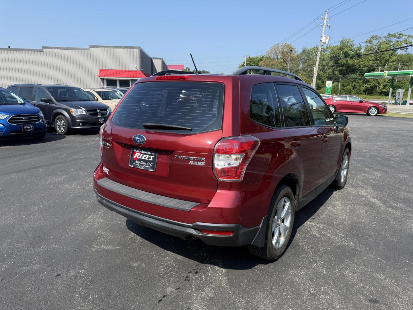 2015 Red /Gray Subaru Forester 2.5i (JF2SJABC5FH) with an 2.5L H4 DOHC 16V engine, Automatic transmission, located at 11115 Chardon Rd. , Chardon, OH, 44024, (440) 214-9705, 41.580246, -81.241943 - This One Owner 2015 Subaru Forester 2.5i features a 2.5-liter H4 (horizontally opposed 4-cylinder) engine paired with Subaru's signature Symmetrical All-Wheel Drive system, delivering reliable traction and stability in various driving conditions. It offers an impressive EPA-estimated 31 MPG on the h - Photo#7