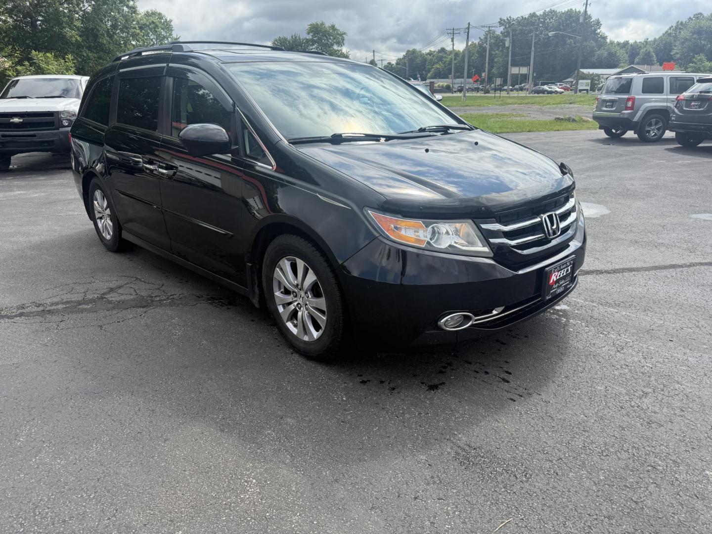 2014 Black /Gray Honda Odyssey EX-L (5FNRL5H6XEB) with an 3.5L V6 SOHC 24V engine, 6-Speed Automatic transmission, located at 547 E. Main St., Orwell, OH, 44076, (440) 437-5893, 41.535435, -80.847855 - This 2014 Honda Odyssey EX-L with Navigation is a well-equipped minivan featuring a 3.5L V6 engine and a 6-speed automatic transmission, delivering up to 27 MPG on the highway. It offers a comfortable ride with leather, heated, and power front seats, tri-zone automatic climate control, and a power m - Photo#2