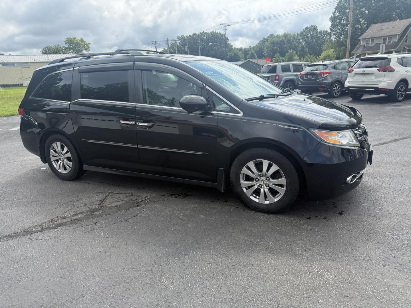 2014 Black /Gray Honda Odyssey EX-L (5FNRL5H6XEB) with an 3.5L V6 SOHC 24V engine, 6-Speed Automatic transmission, located at 547 E. Main St., Orwell, OH, 44076, (440) 437-5893, 41.535435, -80.847855 - This 2014 Honda Odyssey EX-L with Navigation is a well-equipped minivan featuring a 3.5L V6 engine and a 6-speed automatic transmission, delivering up to 27 MPG on the highway. It offers a comfortable ride with leather, heated, and power front seats, tri-zone automatic climate control, and a power m - Photo#3
