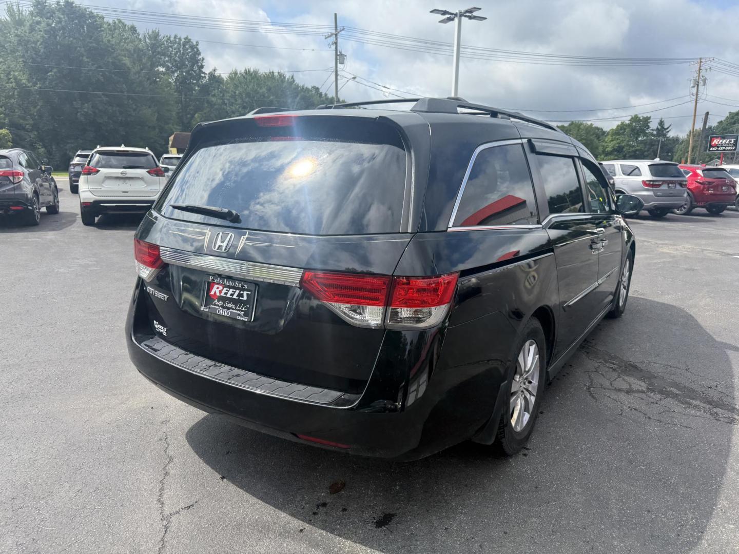 2014 Black /Gray Honda Odyssey EX-L (5FNRL5H6XEB) with an 3.5L V6 SOHC 24V engine, 6-Speed Automatic transmission, located at 547 E. Main St., Orwell, OH, 44076, (440) 437-5893, 41.535435, -80.847855 - This 2014 Honda Odyssey EX-L with Navigation is a well-equipped minivan featuring a 3.5L V6 engine and a 6-speed automatic transmission, delivering up to 27 MPG on the highway. It offers a comfortable ride with leather, heated, and power front seats, tri-zone automatic climate control, and a power m - Photo#7