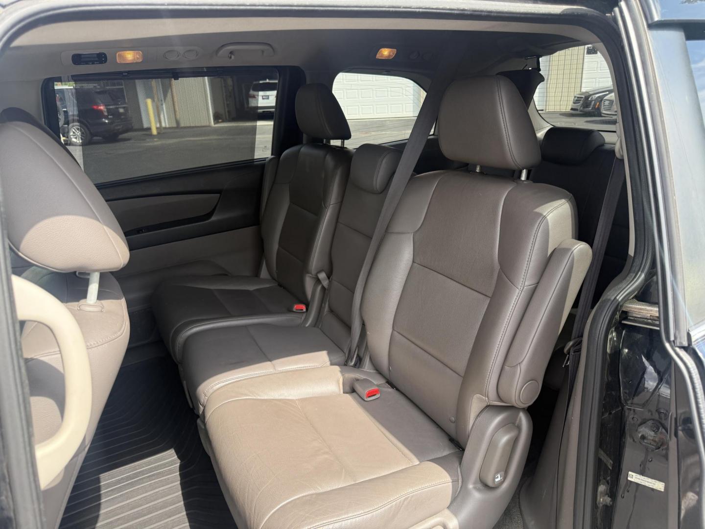 2014 Black /Gray Honda Odyssey EX-L (5FNRL5H6XEB) with an 3.5L V6 SOHC 24V engine, 6-Speed Automatic transmission, located at 547 E. Main St., Orwell, OH, 44076, (440) 437-5893, 41.535435, -80.847855 - This 2014 Honda Odyssey EX-L with Navigation is a well-equipped minivan featuring a 3.5L V6 engine and a 6-speed automatic transmission, delivering up to 27 MPG on the highway. It offers a comfortable ride with leather, heated, and power front seats, tri-zone automatic climate control, and a power m - Photo#38