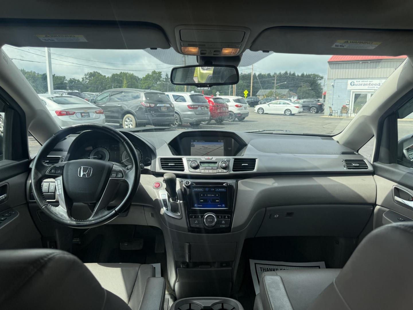 2014 Black /Gray Honda Odyssey EX-L (5FNRL5H6XEB) with an 3.5L V6 SOHC 24V engine, 6-Speed Automatic transmission, located at 547 E. Main St., Orwell, OH, 44076, (440) 437-5893, 41.535435, -80.847855 - This 2014 Honda Odyssey EX-L with Navigation is a well-equipped minivan featuring a 3.5L V6 engine and a 6-speed automatic transmission, delivering up to 27 MPG on the highway. It offers a comfortable ride with leather, heated, and power front seats, tri-zone automatic climate control, and a power m - Photo#40
