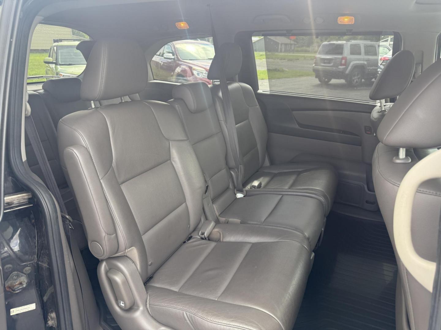 2014 Black /Gray Honda Odyssey EX-L (5FNRL5H6XEB) with an 3.5L V6 SOHC 24V engine, 6-Speed Automatic transmission, located at 547 E. Main St., Orwell, OH, 44076, (440) 437-5893, 41.535435, -80.847855 - This 2014 Honda Odyssey EX-L with Navigation is a well-equipped minivan featuring a 3.5L V6 engine and a 6-speed automatic transmission, delivering up to 27 MPG on the highway. It offers a comfortable ride with leather, heated, and power front seats, tri-zone automatic climate control, and a power m - Photo#43