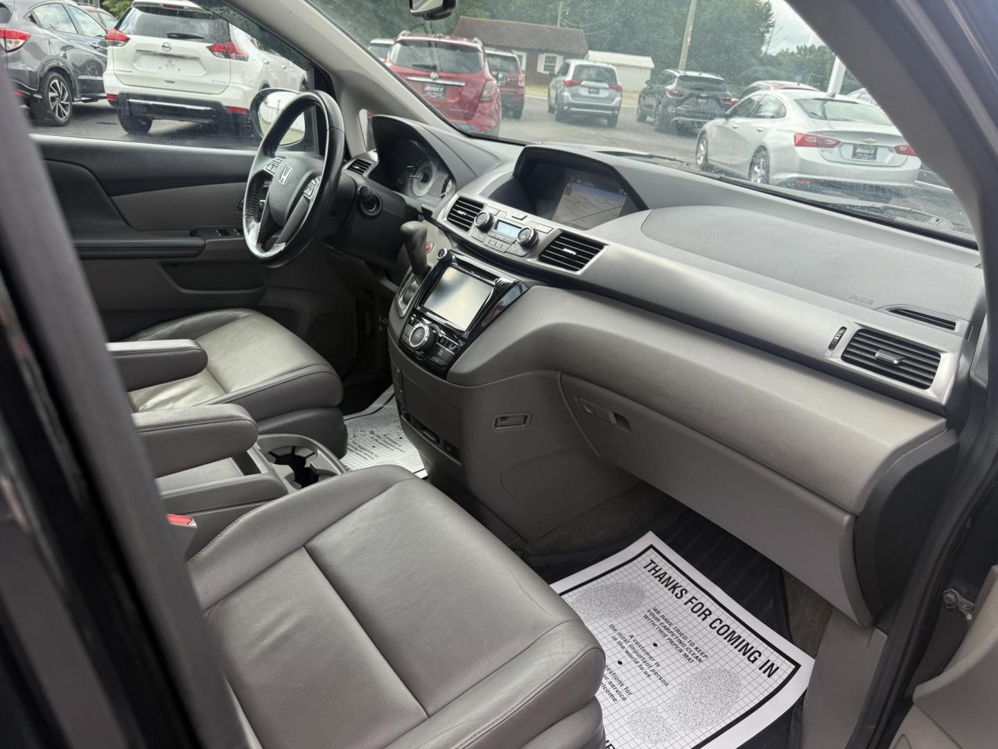 2014 Black /Gray Honda Odyssey EX-L (5FNRL5H6XEB) with an 3.5L V6 SOHC 24V engine, 6-Speed Automatic transmission, located at 547 E. Main St., Orwell, OH, 44076, (440) 437-5893, 41.535435, -80.847855 - This 2014 Honda Odyssey EX-L with Navigation is a well-equipped minivan featuring a 3.5L V6 engine and a 6-speed automatic transmission, delivering up to 27 MPG on the highway. It offers a comfortable ride with leather, heated, and power front seats, tri-zone automatic climate control, and a power m - Photo#44