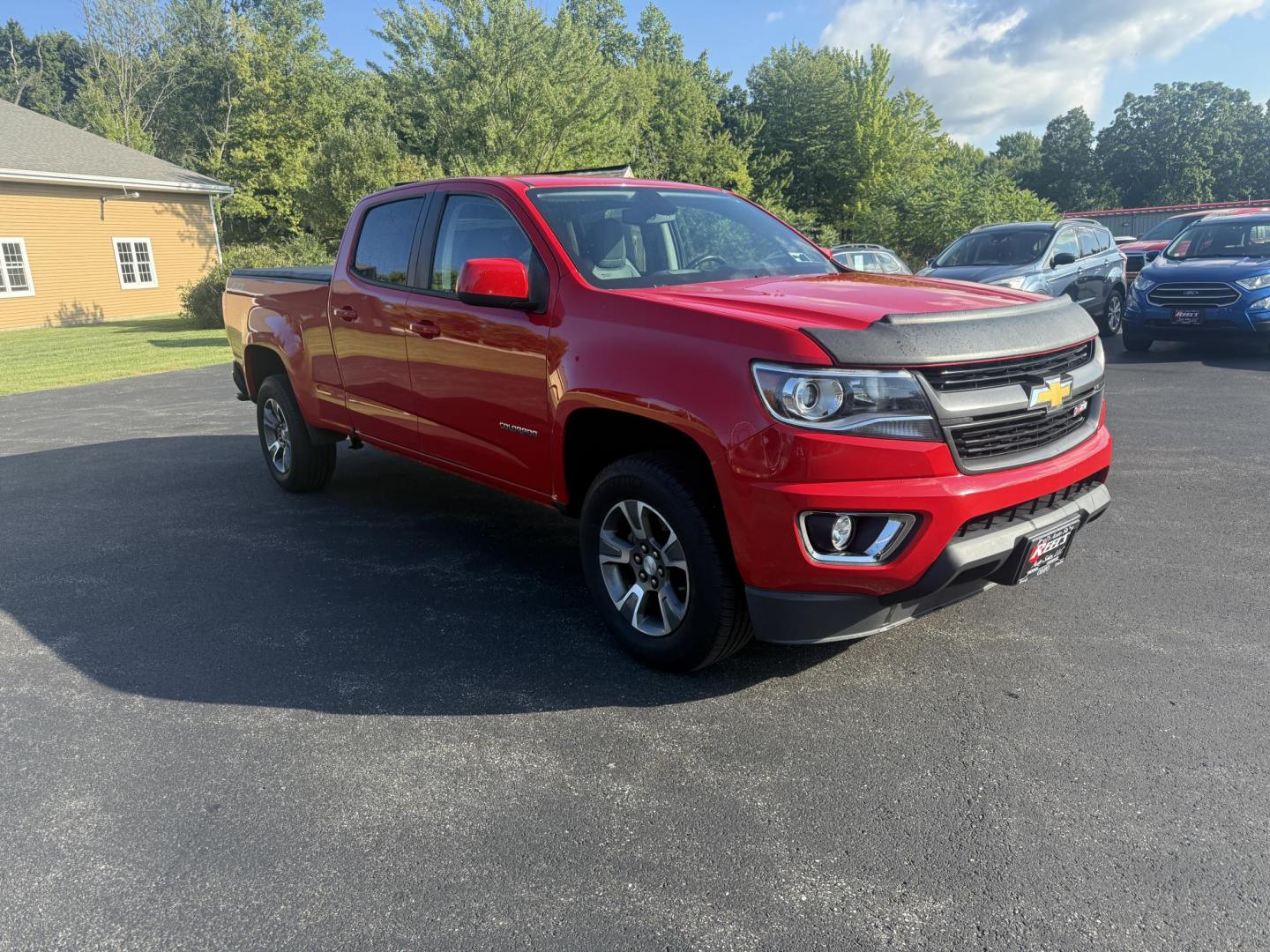 2015 Red /Black Chevrolet Colorado Z71 Crew Cab 4WD Long Box (1GCGTCE34F1) with an 3.6L V6 DOHC 24V GAS engine, 6-Speed Automatic transmission, located at 11115 Chardon Rd. , Chardon, OH, 44024, (440) 214-9705, 41.580246, -81.241943 - This 2015 Chevrolet Colorado Z71 Crew Cab 4WD, equipped with a 3.6L V6 engine and a 6-speed automatic transmission, delivers a balanced mix of power and efficiency with up to 24 MPG highway and a 7,000-pound towing capacity thanks to its 3.42 gearing and G80 locking rear differential. This midsize t - Photo#2