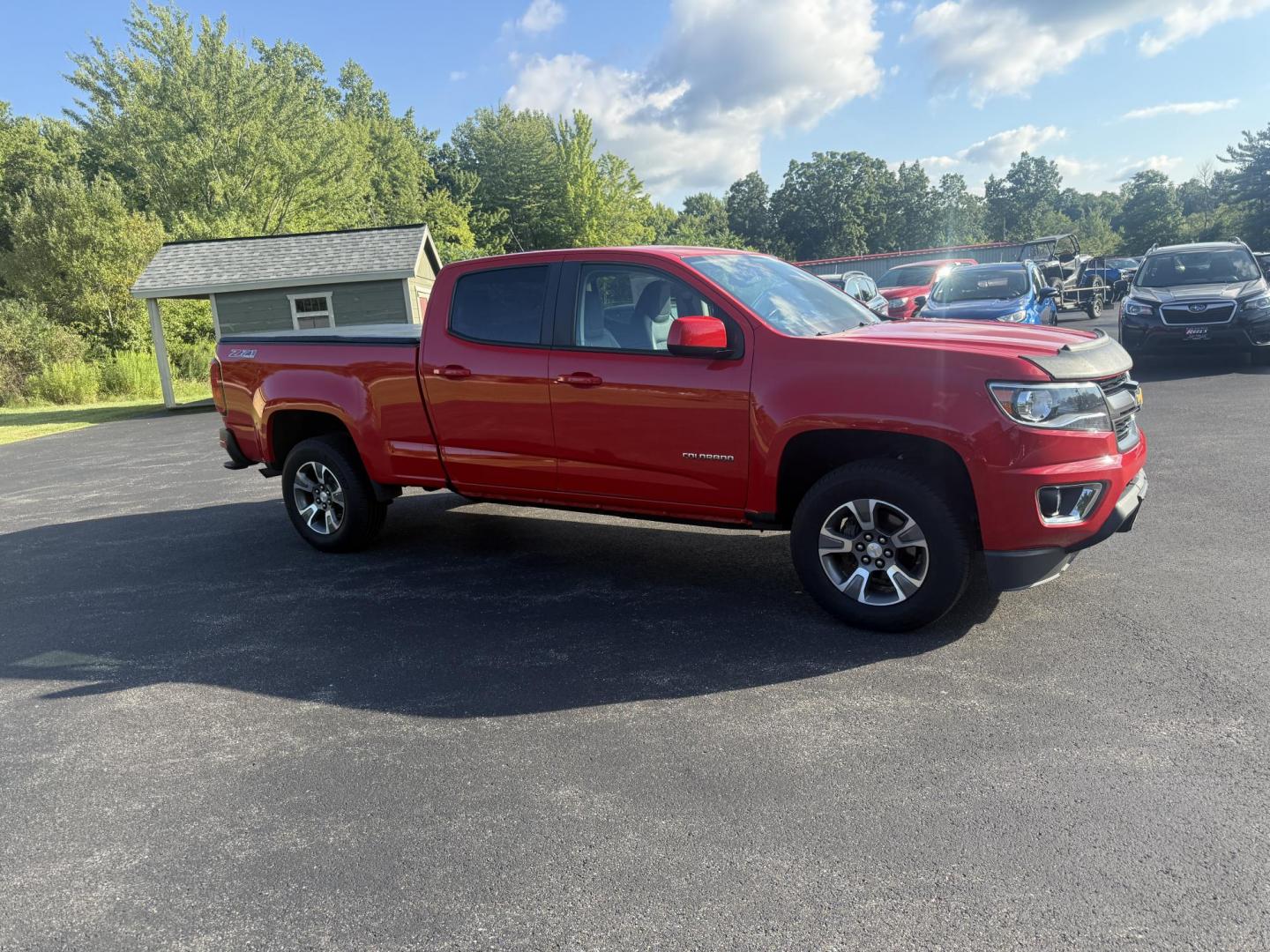 2015 Red /Black Chevrolet Colorado Z71 Crew Cab 4WD Long Box (1GCGTCE34F1) with an 3.6L V6 DOHC 24V GAS engine, 6-Speed Automatic transmission, located at 11115 Chardon Rd. , Chardon, OH, 44024, (440) 214-9705, 41.580246, -81.241943 - This 2015 Chevrolet Colorado Z71 Crew Cab 4WD, equipped with a 3.6L V6 engine and a 6-speed automatic transmission, delivers a balanced mix of power and efficiency with up to 24 MPG highway and a 7,000-pound towing capacity thanks to its 3.42 gearing and G80 locking rear differential. This midsize t - Photo#3