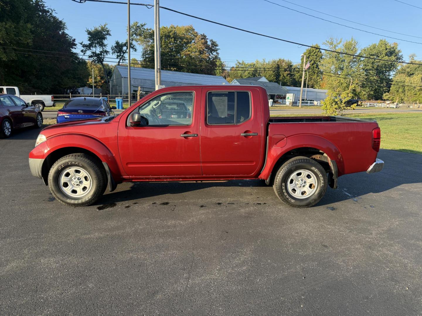 2015 Red /Gray Nissan Frontier S Crew Cab 5AT 4WD (1N6AD0EV7FN) with an 4.0L V6 DOHC 24V engine, 5-Speed Automatic transmission, located at 11115 Chardon Rd. , Chardon, OH, 44024, (440) 214-9705, 41.580246, -81.241943 - This One Owner 2015 Nissan Frontier S Crew Cab 4WD is powered by a robust 4.0L V6 engine mated to a 5-speed automatic transmission, offering a towing capacity of up to 6,100 pounds. It features a Dana 44 rear axle and active brake limited slip differentials, enhancing traction and off-road capabilit - Photo#12