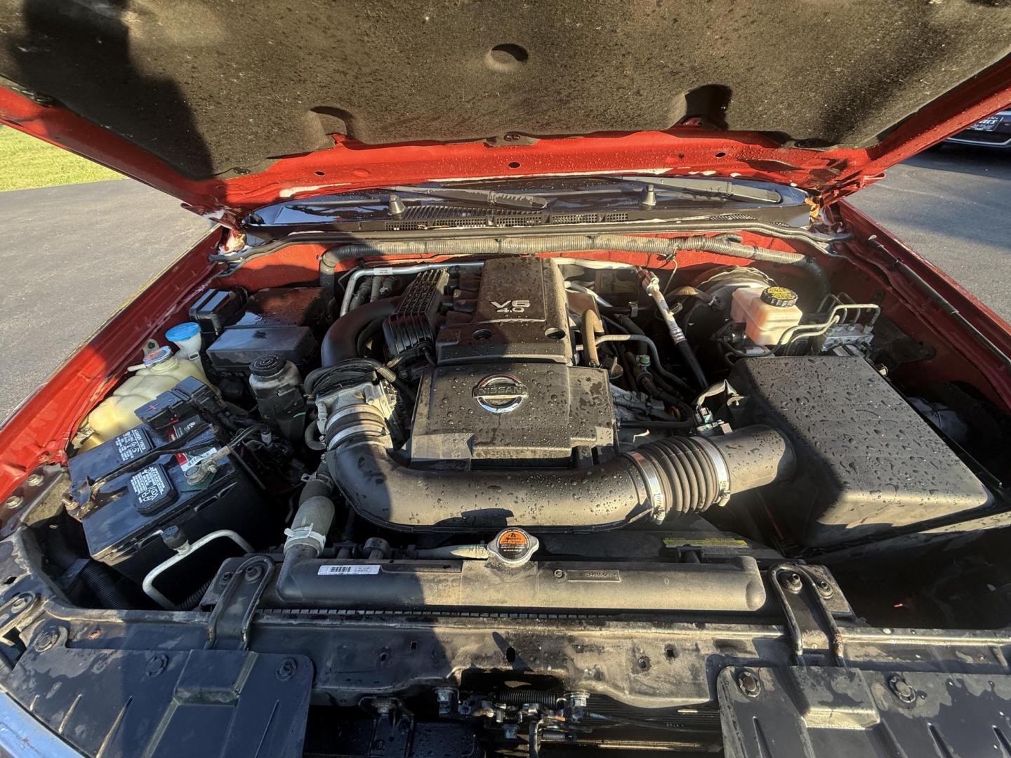 2015 Red /Gray Nissan Frontier S Crew Cab 5AT 4WD (1N6AD0EV7FN) with an 4.0L V6 DOHC 24V engine, 5-Speed Automatic transmission, located at 11115 Chardon Rd. , Chardon, OH, 44024, (440) 214-9705, 41.580246, -81.241943 - This One Owner 2015 Nissan Frontier S Crew Cab 4WD is powered by a robust 4.0L V6 engine mated to a 5-speed automatic transmission, offering a towing capacity of up to 6,100 pounds. It features a Dana 44 rear axle and active brake limited slip differentials, enhancing traction and off-road capabilit - Photo#14