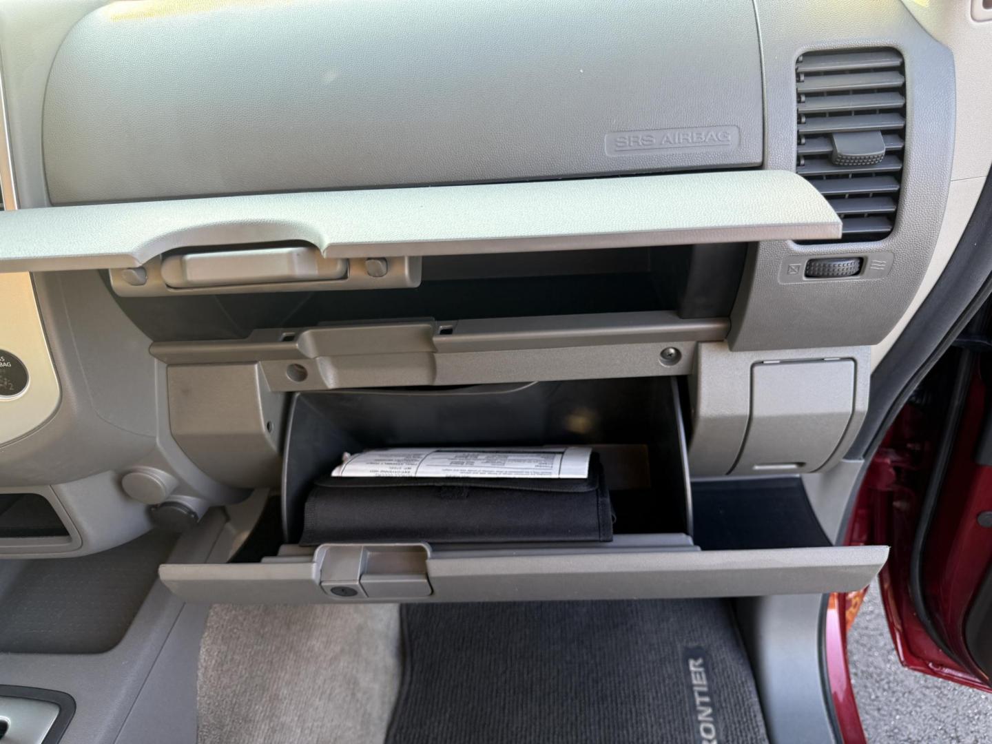 2015 Red /Gray Nissan Frontier S Crew Cab 5AT 4WD (1N6AD0EV7FN) with an 4.0L V6 DOHC 24V engine, 5-Speed Automatic transmission, located at 11115 Chardon Rd. , Chardon, OH, 44024, (440) 214-9705, 41.580246, -81.241943 - This One Owner 2015 Nissan Frontier S Crew Cab 4WD is powered by a robust 4.0L V6 engine mated to a 5-speed automatic transmission, offering a towing capacity of up to 6,100 pounds. It features a Dana 44 rear axle and active brake limited slip differentials, enhancing traction and off-road capabilit - Photo#37