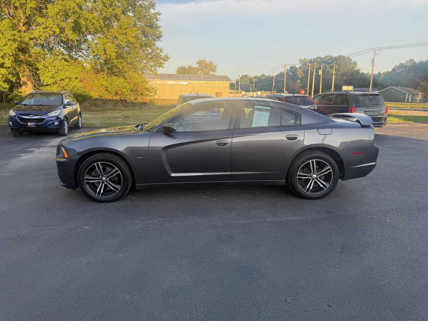 2014 Gray /Black Dodge Charger R/T AWD (2C3CDXDT6EH) with an 5.7L V8 OHV 16V engine, 5-Speed Automatic transmission, located at 547 E. Main St., Orwell, OH, 44076, (440) 437-5893, 41.535435, -80.847855 - This 2014 Dodge Charger R/T AWD is a powerful and stylish full-size sedan equipped with a 5.7L HEMI V8 engine that delivers 370 horsepower and 395 lb-ft of torque. Featuring a 5-speed automatic transmission and all-wheel drive, it accelerates from 0 to 60 mph in approximately 5.2 seconds, offering i - Photo#12