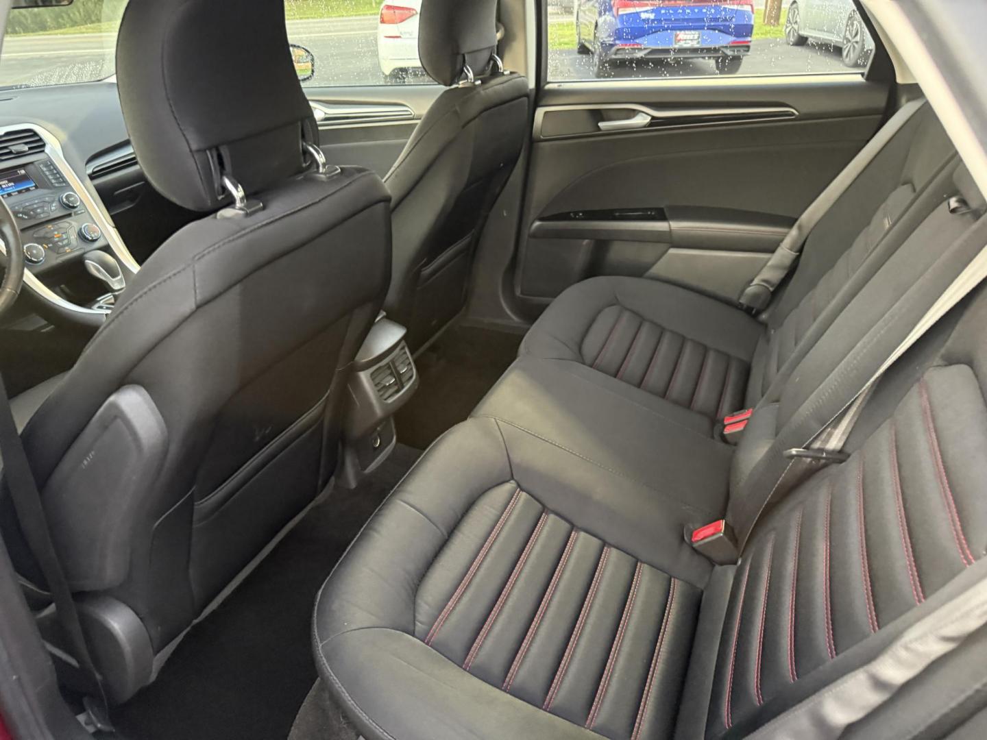 2015 Red /Black Ford Fusion SE (3FA6P0H98FR) with an 2.0L I4 DOHC 16V Turbo engine, 6-Speed Automatic transmission, located at 11115 Chardon Rd. , Chardon, OH, 44024, (440) 214-9705, 41.580246, -81.241943 - This One Owner 2015 Ford Fusion SE is a stylish and efficient midsize sedan powered by a 2.0L I4 EcoBoost engine paired with a 6-speed automatic transmission. This combination delivers a satisfying balance of performance and fuel economy, achieving up to 33 MPG on the highway. The SE trim offers com - Photo#31