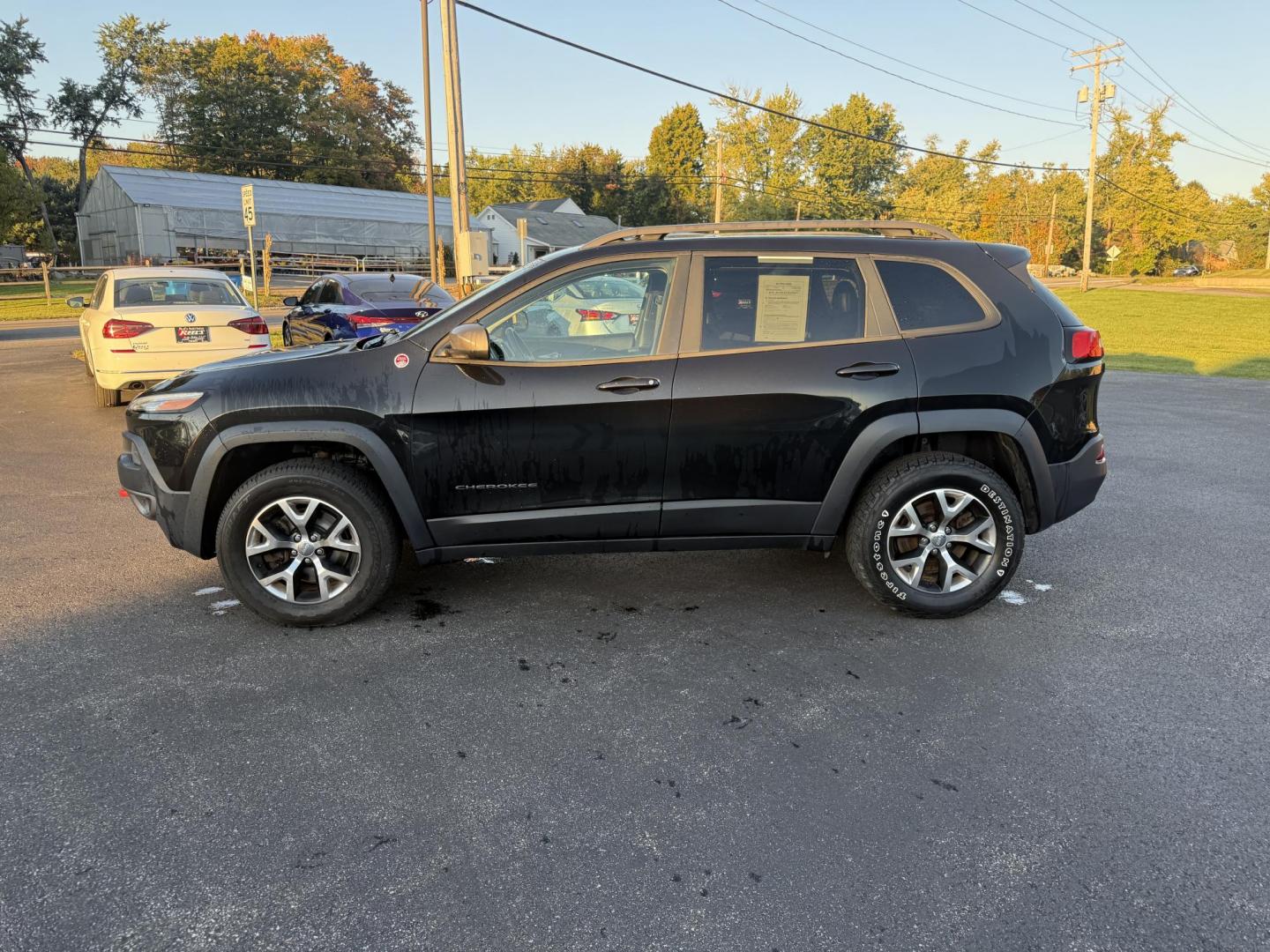 2016 Black /Black Jeep Cherokee Trailhawk 4WD (1C4PJMBS1GW) with an 3.2L V6 DOHC 24V engine, 9A transmission, located at 11115 Chardon Rd. , Chardon, OH, 44024, (440) 214-9705, 41.580246, -81.241943 - This 2016 Jeep Cherokee Trailhawk 4WD is powered by a robust 3.2L V6 engine paired with a 9-speed automatic transmission, delivering strong off-road capability with features like Jeep Active Drive Lock and a locking rear differential. Inside, it offers a leather interior, heated front seats, power d - Photo#13