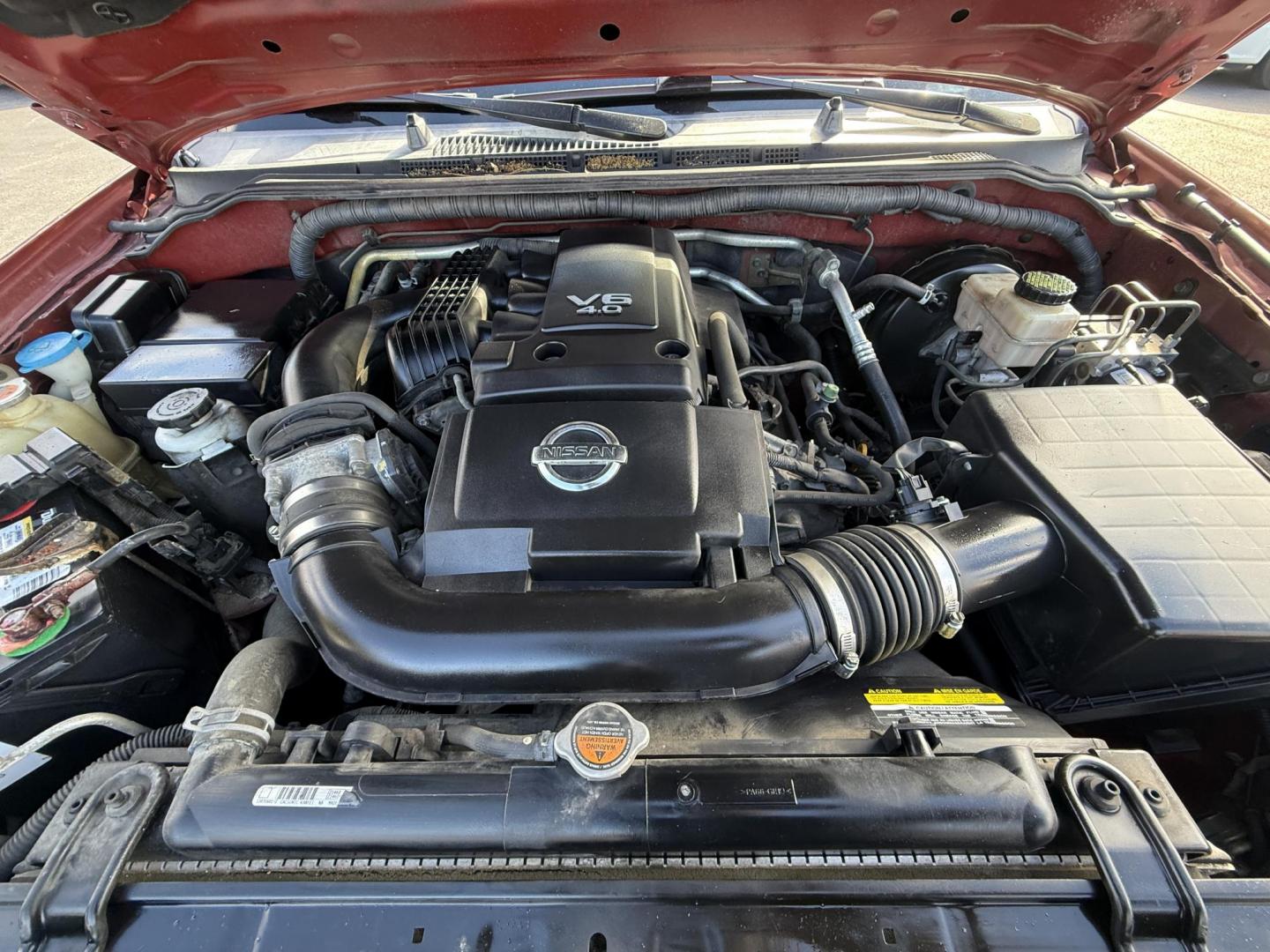 2016 Red /Gray Nissan Frontier SV Crew Cab 5AT 4WD (1N6AD0EV0GN) with an 4.0L V6 DOHC 24V engine, 5A transmission, located at 11115 Chardon Rd. , Chardon, OH, 44024, (440) 214-9705, 41.580246, -81.241943 - Tackle any job or adventure with this 2016 Nissan Frontier SV Crew Cab. Powered by a reliable 4.0L V6 engine and 5-speed automatic transmission, this truck offers a strong 6,300-pound towing capacity and is equipped with a Dana 44 rear axle for added durability. Enjoy added confidence on any terrain - Photo#16