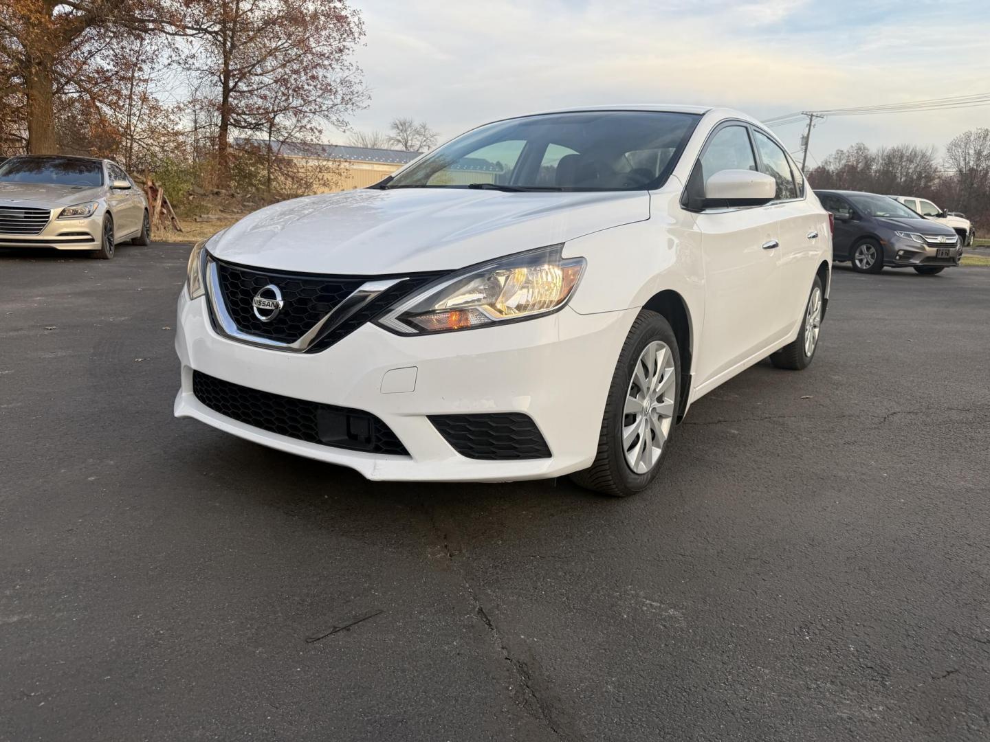 2019 White /Black Nissan Sentra S CVT (3N1AB7AP8KY) with an 1.8L I4 SFI DOHC 16V engine, Automatic transmission, located at 547 E. Main St., Orwell, OH, 44076, (440) 437-5893, 41.535435, -80.847855 - 2019 Nissan Sentra S – Efficient, Safe, and Smartly Equipped Enjoy reliability and impressive efficiency in this 2019 Nissan Sentra S. Powered by a fuel-sipping 1.8L I4 engine with ECO mode, this sedan delivers an outstanding 32 MPG combined and up to 37 MPG highway—making it the ideal choice - Photo#0