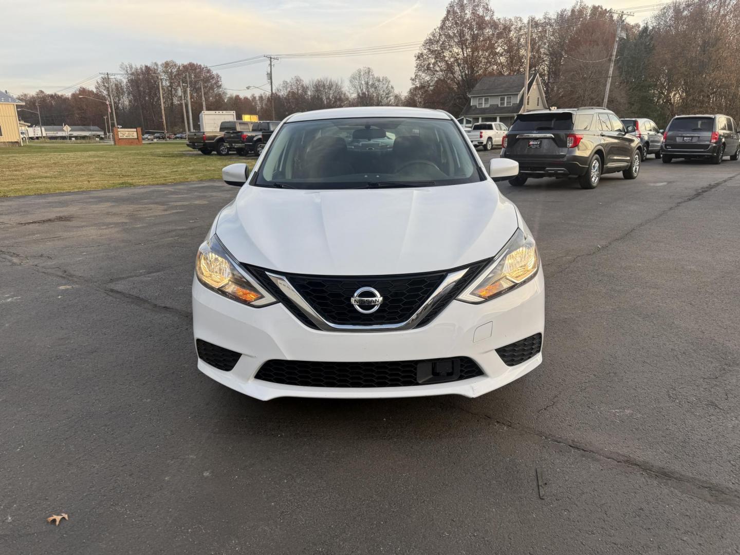 2019 White /Black Nissan Sentra S CVT (3N1AB7AP8KY) with an 1.8L I4 SFI DOHC 16V engine, Automatic transmission, located at 547 E. Main St., Orwell, OH, 44076, (440) 437-5893, 41.535435, -80.847855 - 2019 Nissan Sentra S – Efficient, Safe, and Smartly Equipped Enjoy reliability and impressive efficiency in this 2019 Nissan Sentra S. Powered by a fuel-sipping 1.8L I4 engine with ECO mode, this sedan delivers an outstanding 32 MPG combined and up to 37 MPG highway—making it the ideal choice - Photo#1