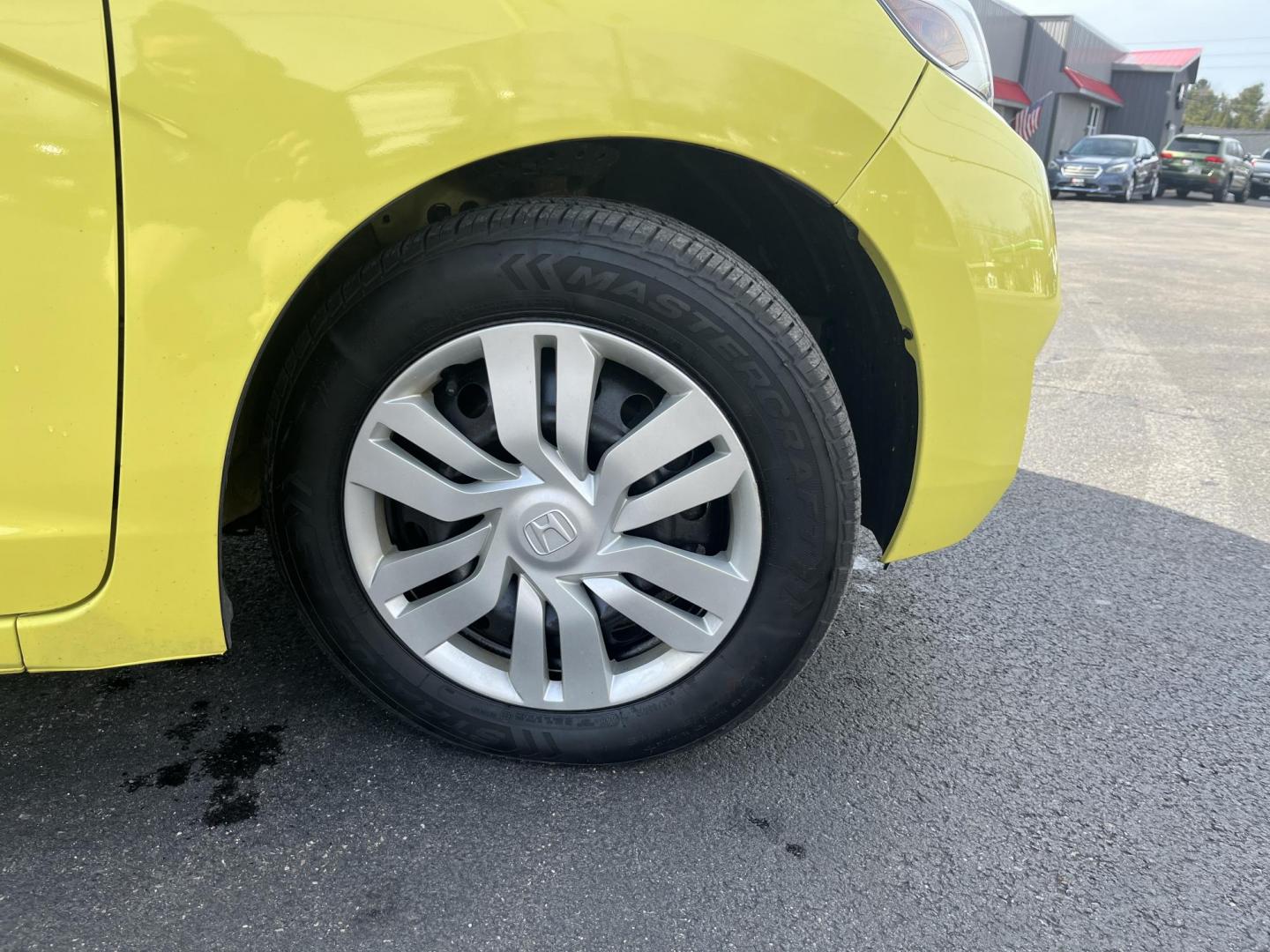 2015 Yellow /Black Honda Fit LX (3HGGK5H56FM) with an 1.5L I4 DOHC 16V engine, Automatic transmission, located at 11115 Chardon Rd. , Chardon, OH, 44024, (440) 214-9705, 41.580246, -81.241943 - 2015 Honda Fit LX – Super-Efficient Hatchback with Fun Personality and Eye-Catching Style! This zippy 2015 Honda Fit LX is the ultimate smart buy for anyone wanting maximum fun, space, and fuel savings in a compact package! Powered by Honda’s reliable 1.5L I4 Earth Dreams engine, it delivers pe - Photo#2