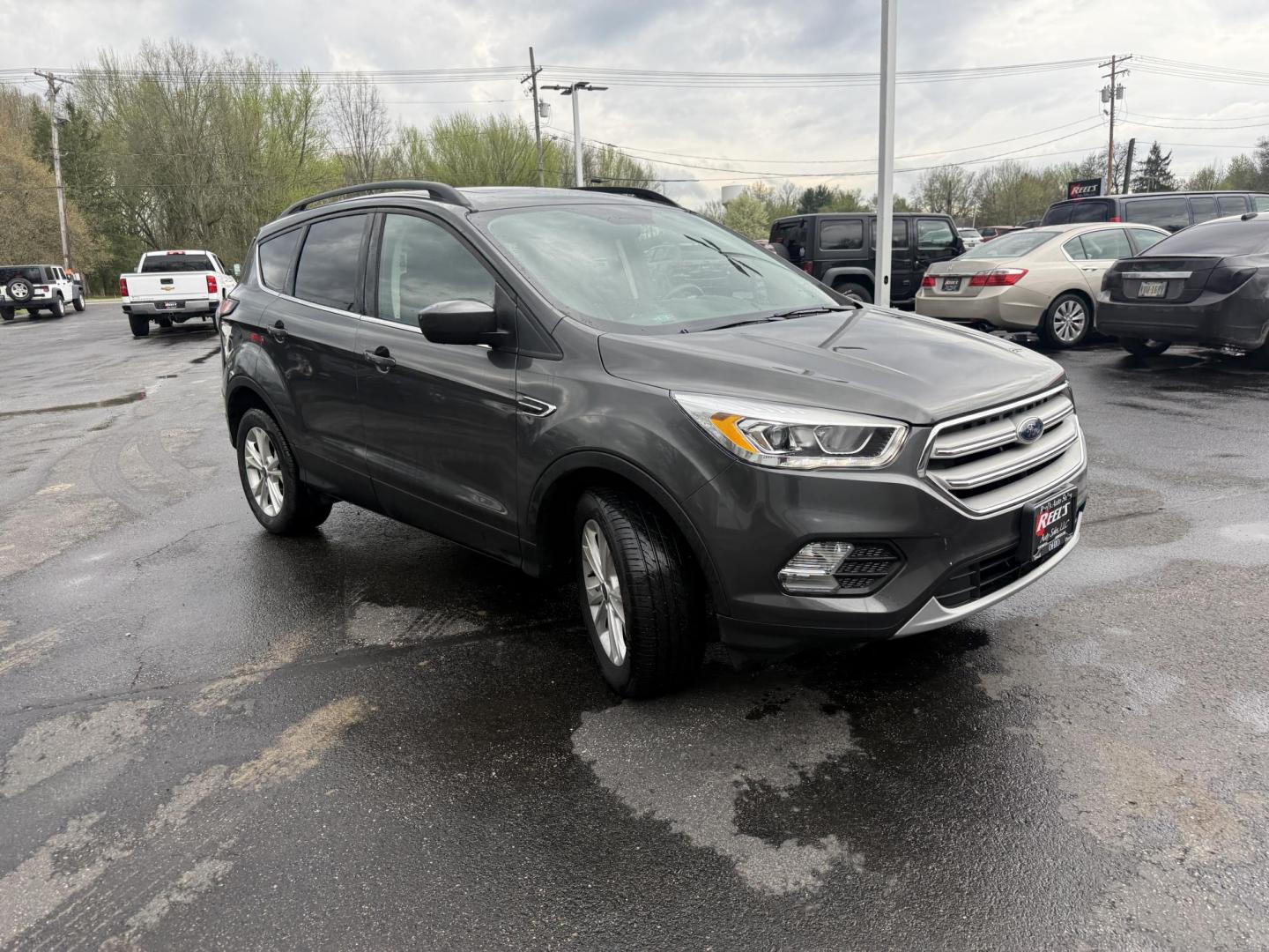 2018 Gray /Black Ford Escape SEL 4WD (1FMCU9HD0JU) with an 1.5L I4 DOHC 16V engine, Automatic transmission, located at 11115 Chardon Rd. , Chardon, OH, 44024, (440) 214-9705, 41.580246, -81.241943 - 2018 Ford Escape SEL 4WD – Turbo Efficiency, Premium Comfort, and All-Weather Confidence! This sharp 2018 Ford Escape SEL 4WD is a great-looking compact crossover that delivers style, comfort, and real capability! Powered by a responsive 1.5L I4 Turbocharged EcoBoost engine paired with a smooth 6 - Photo#2