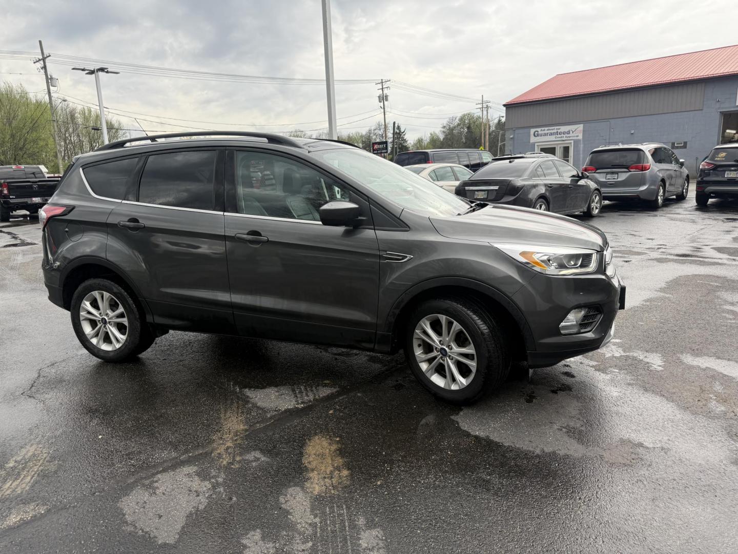 2018 Gray /Black Ford Escape SEL 4WD (1FMCU9HD0JU) with an 1.5L I4 DOHC 16V engine, Automatic transmission, located at 11115 Chardon Rd. , Chardon, OH, 44024, (440) 214-9705, 41.580246, -81.241943 - 2018 Ford Escape SEL 4WD – Turbo Efficiency, Premium Comfort, and All-Weather Confidence! This sharp 2018 Ford Escape SEL 4WD is a great-looking compact crossover that delivers style, comfort, and real capability! Powered by a responsive 1.5L I4 Turbocharged EcoBoost engine paired with a smooth 6 - Photo#3