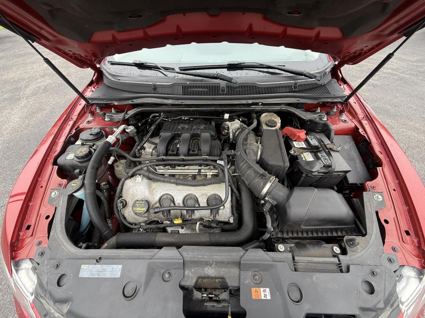 2012 Red /Black Ford Taurus SEL FWD (1FAHP2EWXCG) with an 3.5L V6 DOHC 24V engine, 6-Speed Automatic transmission, located at 11115 Chardon Rd. , Chardon, OH, 44024, (440) 214-9705, 41.580246, -81.241943 - 2012 Ford Taurus SEL FWD – Smooth, Spacious, and Efficient Full-Size Sedan! This 2012 Ford Taurus SEL FWD is a comfortable, well-equipped full-size sedan that offers roomy seating, smooth performance, and solid efficiency. Powered by a strong 3.5L V6 engine paired with a smooth 6-speed automatic - Photo#5