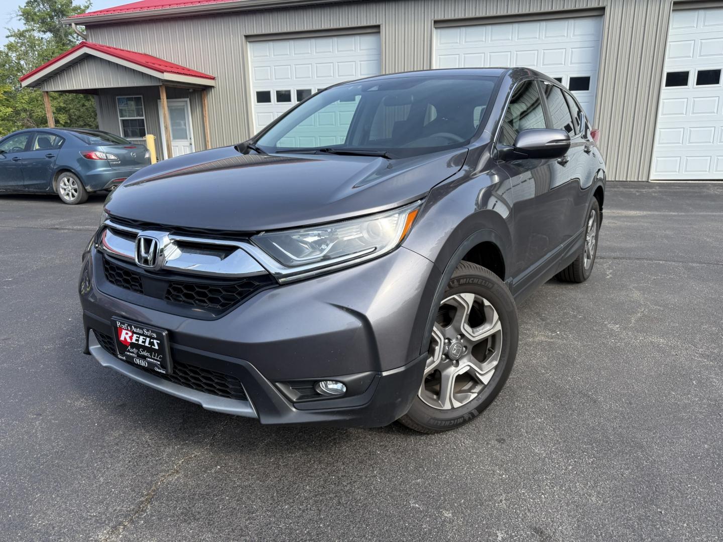 2018 Gray /Black Honda CR-V EX AWD (7FARW2H5XJE) with an 1.5L I4 16V DOHC TURBO engine, Automatic transmission, located at 547 E. Main St., Orwell, OH, 44076, (440) 437-5893, 41.535435, -80.847855 - 2018 Honda CR-V EX AWD – Efficient Compact SUV with One-Owner History and Everyday Comfort If you want a compact SUV that balances efficiency, comfort, and all-weather capability, this 2018 Honda CR-V EX AWD is a strong option. The 1.5L Turbocharged engine delivers responsive power and a solid 33- Photo#0