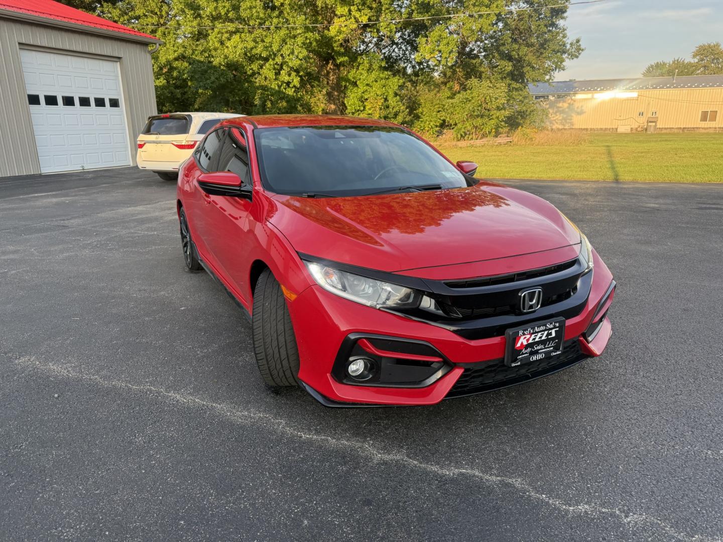 2021 Red /Black Honda Civic Sport Hatchback CVT (SHHFK7H42MU) with an 1.5L I4 16V DOHC TURBO engine, Automatic transmission, located at 547 E. Main St., Orwell, OH, 44076, (440) 437-5893, 41.535435, -80.847855 - 2021 Honda Civic Hatchback Sport – Efficient, Sporty, and Easy to Live With If you want a compact hatchback that feels current, efficient, and enjoyable to drive, this 2021 Honda Civic Hatchback Sport is a strong option. The 1.5L Turbocharged engine delivers responsive power and an impressive 40- Photo#2