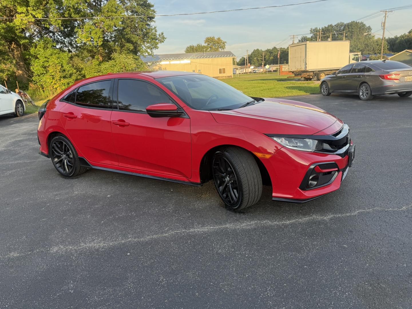 2021 Red /Black Honda Civic Sport Hatchback CVT (SHHFK7H42MU) with an 1.5L I4 16V DOHC TURBO engine, Automatic transmission, located at 547 E. Main St., Orwell, OH, 44076, (440) 437-5893, 41.535435, -80.847855 - 2021 Honda Civic Hatchback Sport – Efficient, Sporty, and Easy to Live With If you want a compact hatchback that feels current, efficient, and enjoyable to drive, this 2021 Honda Civic Hatchback Sport is a strong option. The 1.5L Turbocharged engine delivers responsive power and an impressive 40- Photo#3